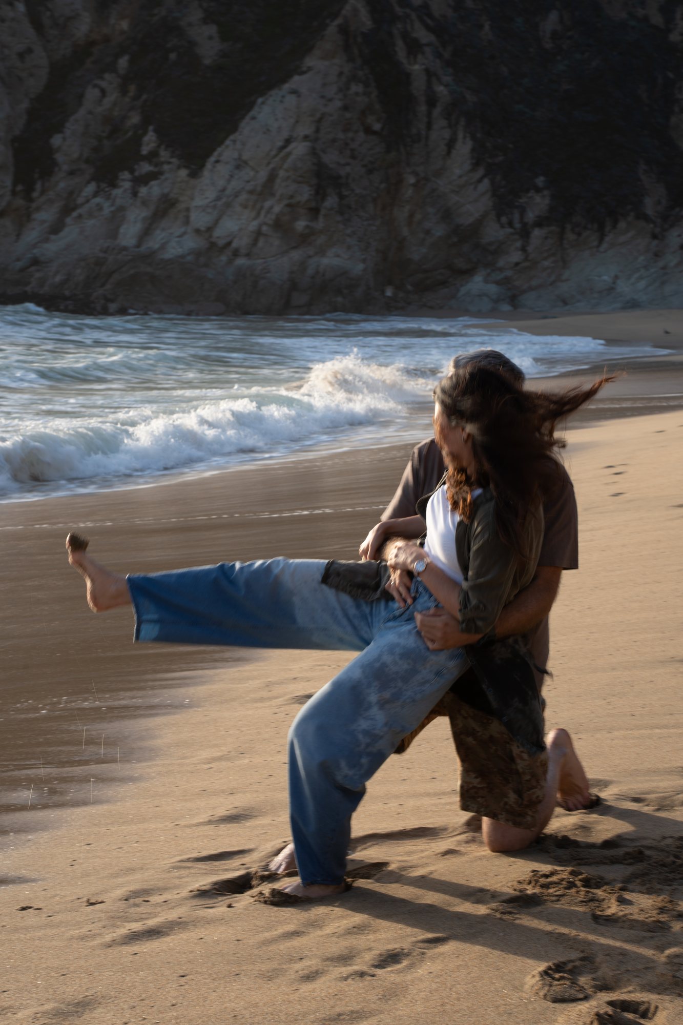 A playful moment together on the shoreline