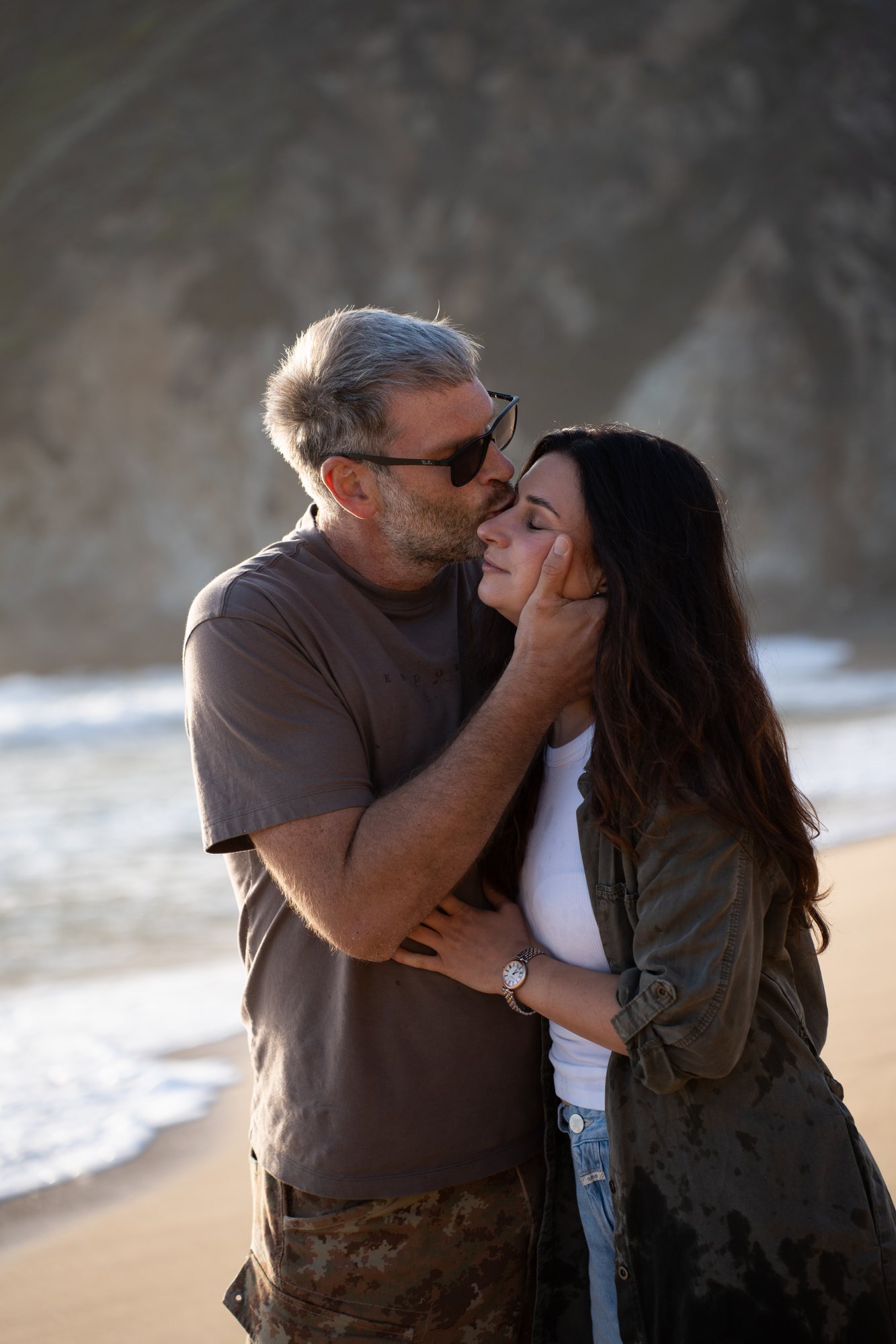 A close embrace against the coastal cliffs