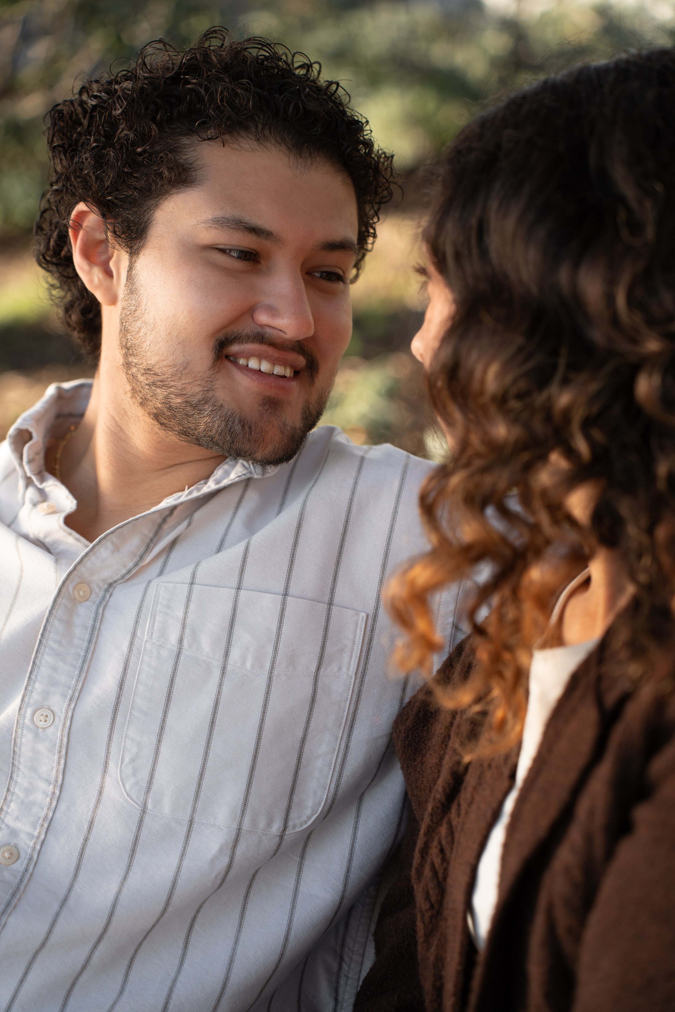 The man smiling at his partner