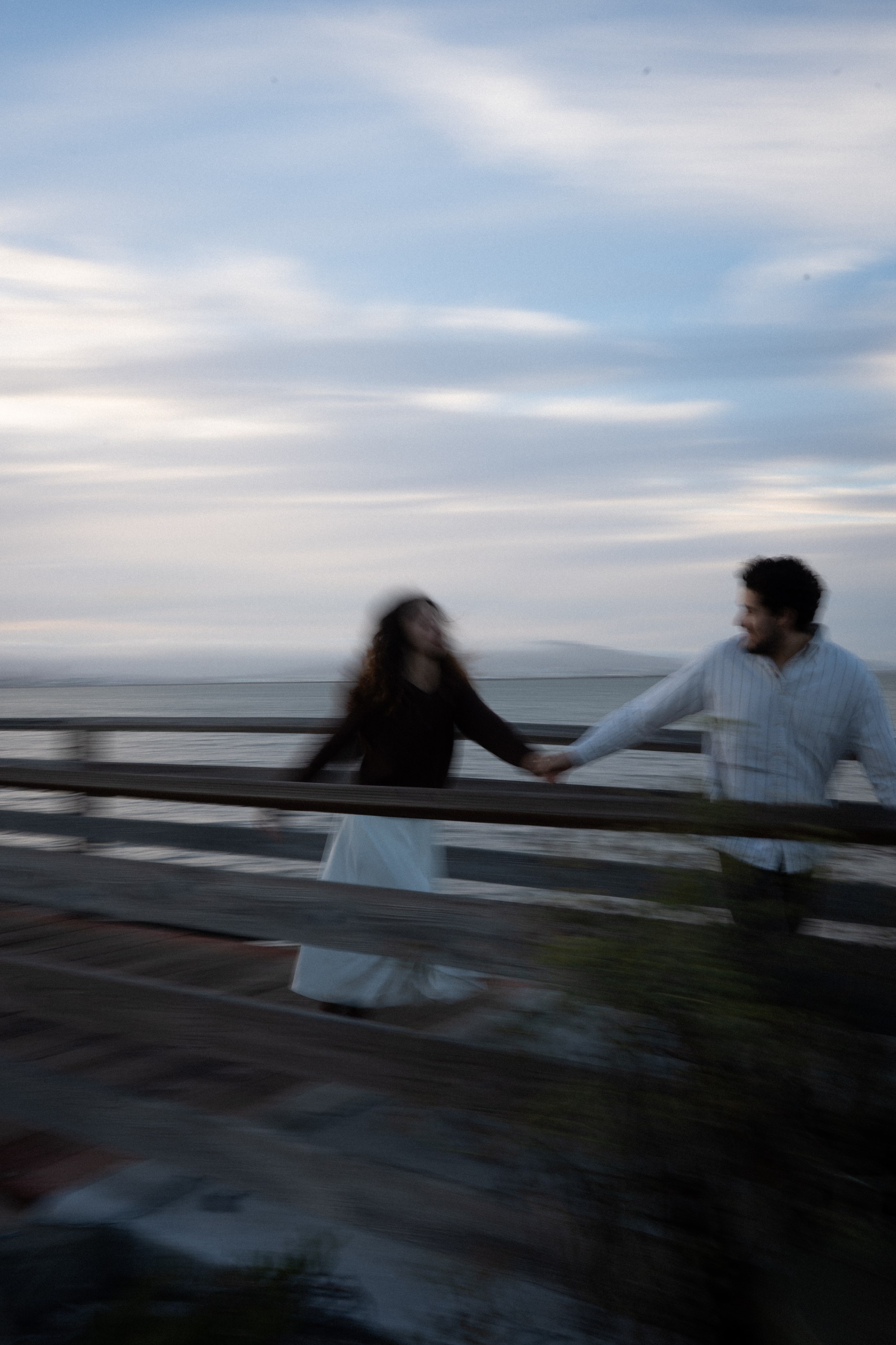 The couple moving together along the railing, with a little artistic motion blur