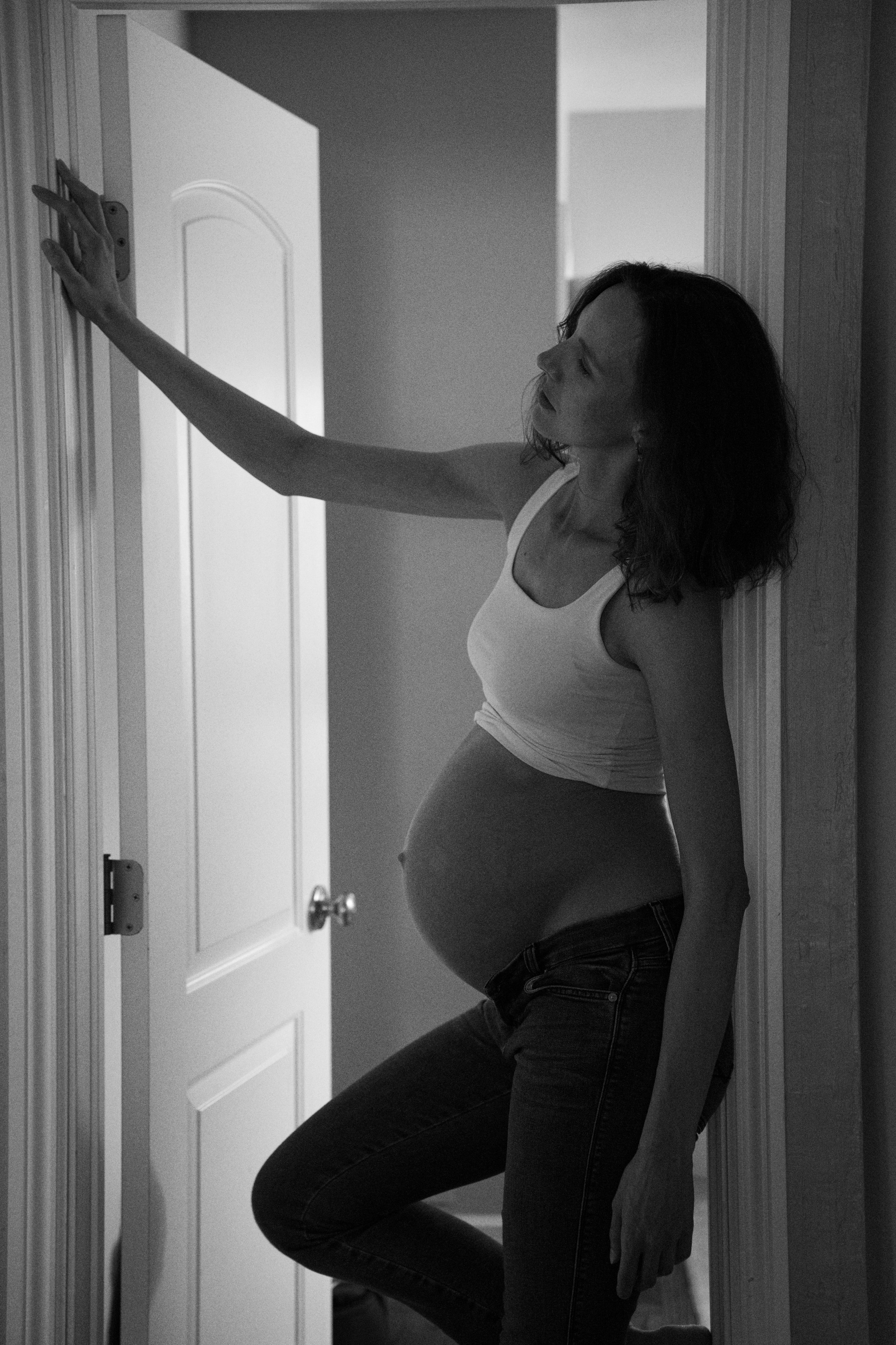 A playful black-and-white pose by the door