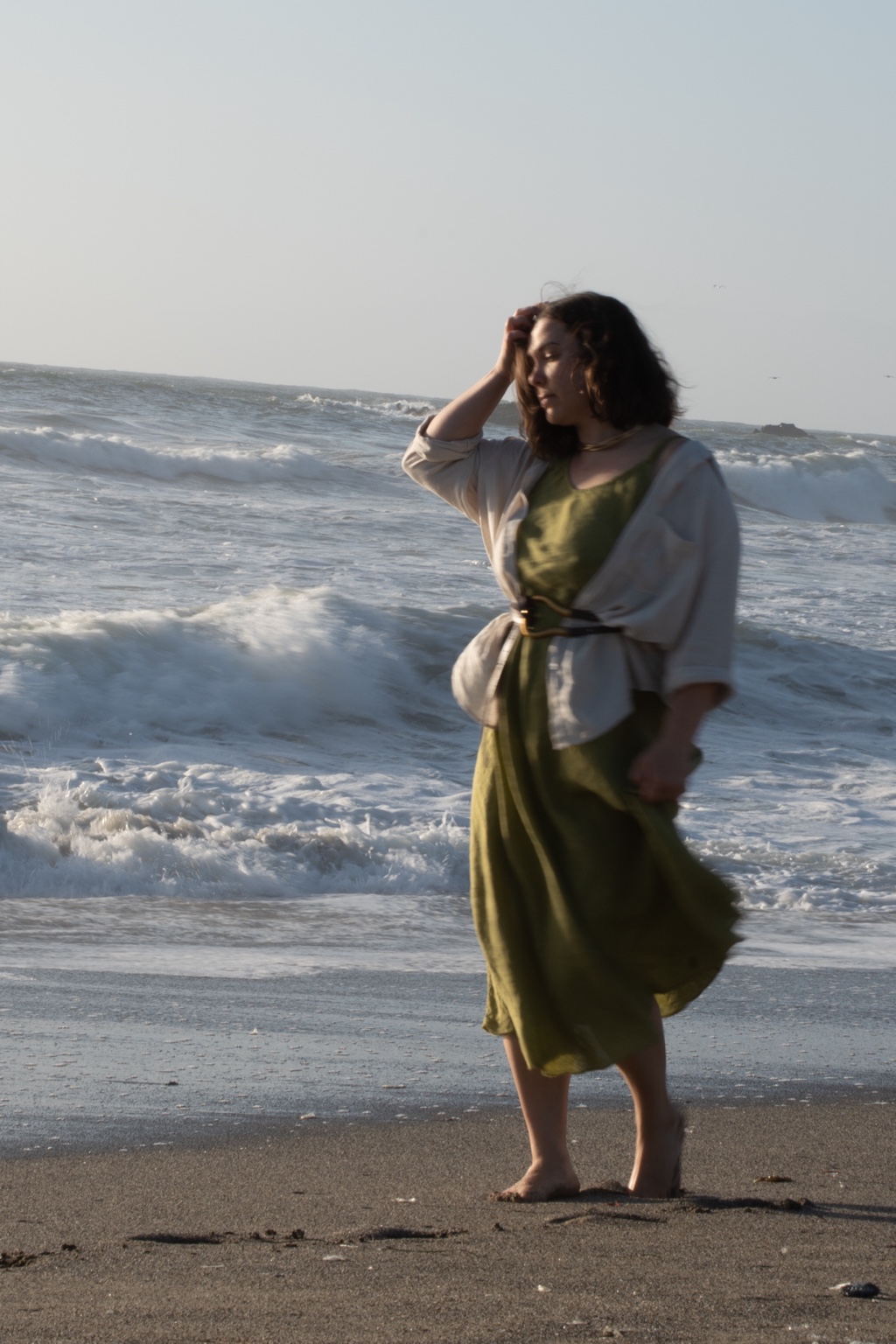 A woman with a slight motion blur standing in the surf
