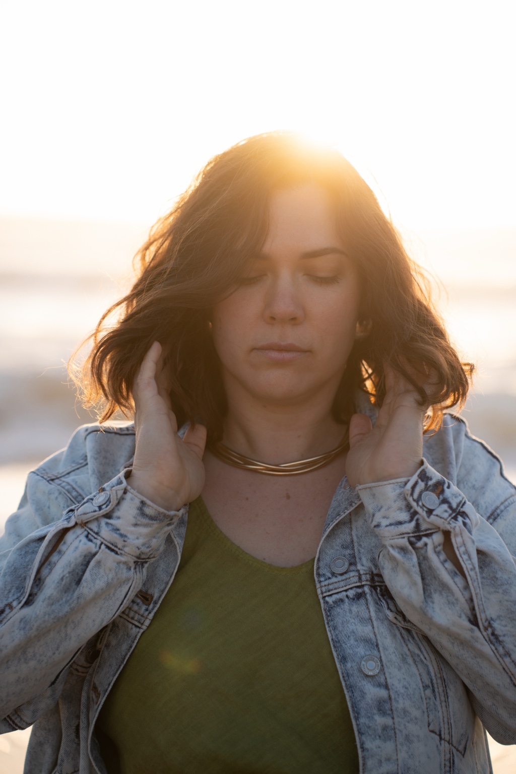 A quiet, backlit portrait with eyes closed